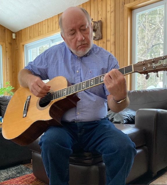 Alan Franko playing acoustic guitar